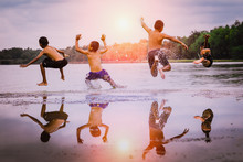 Young Boys Jumping Into The Lake.