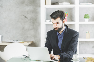 Wall Mural - Focused man using laptop