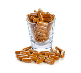 Sticker - Pill.Tumeric powder capsules on white background.