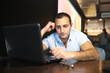 © alexkich - Armenian handsome man working behind laptop