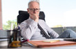© thodonal - Portrait of thoughtful businessman sitting