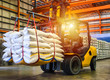 Forklift handling sugar bag for stuffing into container for export,