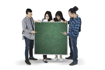 Wall Mural - Diversity students showing a blank chalkboard