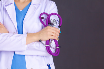 Wall Mural - Woman doctor standing with folder at hospital