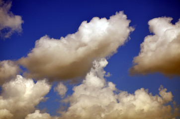 deep blue sky with dark moody clouds