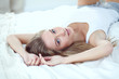 © lenets_tan - Pretty woman lying down on her bed at home . Pretty woman