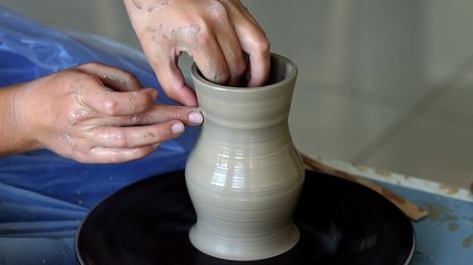 Wall Mural - Creating jar or vase of clay. Woman hands, potter's wheel