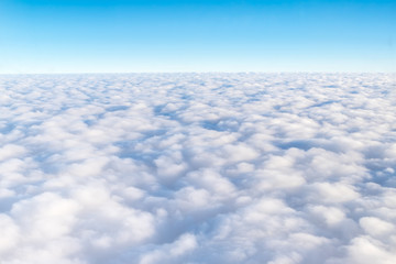 Wall Mural - blue sky and cloud top view from airplane window,nature background