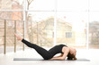 © Africa Studio - Young woman practicing yoga against window