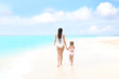 © Africa Studio - Beautiful young woman with her daughter on beach at sea resort