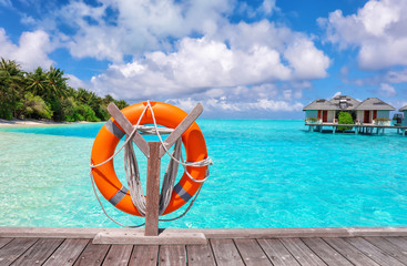 Poster - Wooden pontoon with flotation ring at tropical resort