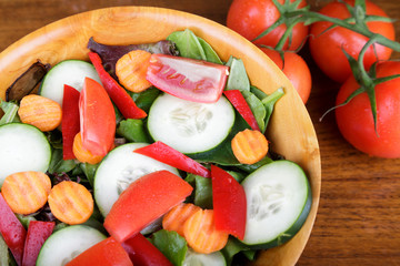 Wall Mural - Large Mixed Salad in Wood Bowl with Fresh Tomatoes