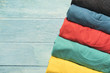 © tatomm - close up of rolled colorful clothes on wood table background