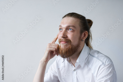Attractive Dreamy Positive Young Male Employee With Thick Beard