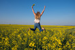 © sanechka - Joyful young woman jumping in field