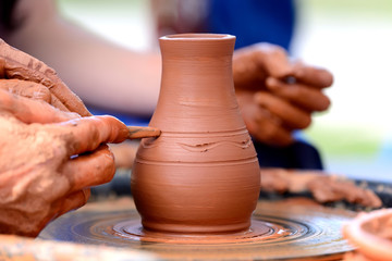 Potter making ceramic pot on the pottery wheel