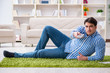 © Elnur - Young handsome man sitting on floor at home