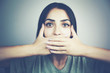 © ARAMYAN - woman covering closed mouth