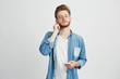 © Cookie Studio - Young handsome man listening to streaming music in headphones with closed eyes enjoying over white background.