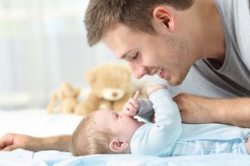 Wall Mural - Baby playing with his father