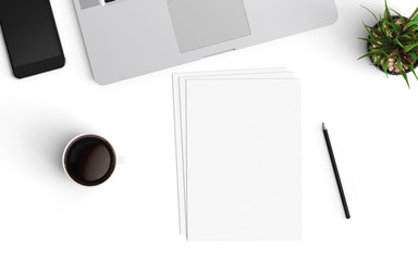 Modern office desk workspace with Laptop, blank paper, coffee cup, pencil and smartphone copy space on white desk background. Top view. Flat lay style.