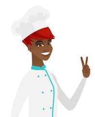 Canvas Print - African-american chef cook showing victory gesture