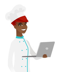 Sticker - Young african-american chef using a laptop.