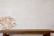 © bongkarn - Mock up wooden table with white brick wall. For product display montage..