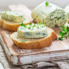 Wall Mural - Sandwiches with herbs butter On Cutting board on white wooden background