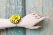 Wrist corsage made of yellow flowers.