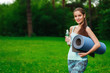© Natalia Chircova - Young woman with a bottle of water and mat, outdoor, summer
