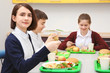 © Africa Studio - Children sitting at table in school cafeteria while eating lunch