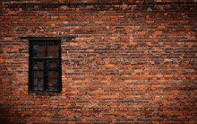 Old Black Brick Wall And Window Locked With Metal Bars