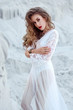 © Merrou - Attractive young woman in white long dress in the desert. Boho S