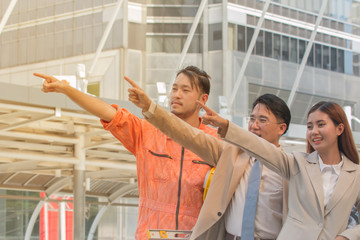 Wall Mural - Asian Young businessmen and engineers view of construction managers controlling building.