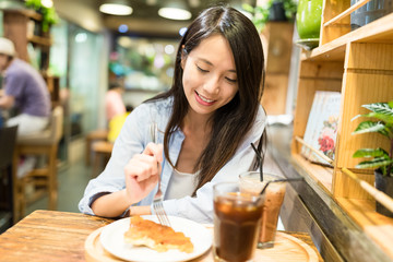 Wall Mural - Young Woman enjoy her food in restaurant