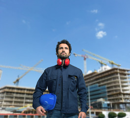 Worker in front of a construction site