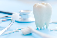 Dental Model And Dental Equipment On Blue Background, Concept Image Of Dental Background. Dental Hygiene Background
