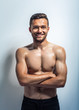 © GVS - Portrait of a smiling muscular shirtless man