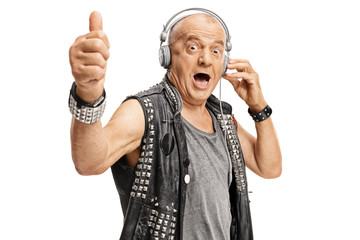 Elderly punker with headphones holding his thumb up