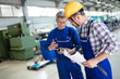 © NDABCREATIVITY - Team Of Engineers Having Discussion In Factory