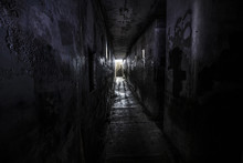 Ghostly Person Standing In A Dark Hallway Of An Abandoned Building 
