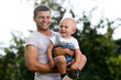 © Maksim Kostenko - Father and son in the countryside on a sunny day.