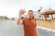 © satura_ - New home, apartment, owner and people concept - Close up of keys that showing young happy man with new home on background