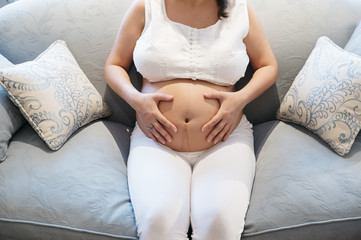 Pregnant woman relaxing at home.