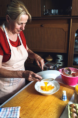 Wall Mural - Close up of female baker hands kneading dough.