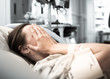 © kieferpix - Young woman patient lying at hospital bed feeling sad and depressed worried. Disease feeling sick in health care and clinical attention concept