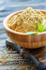 Wall Mural - Wooden bowl with mustard powder.