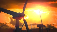 Looping Animation Of Silhouettes Of Wind Turbines At Sunset.