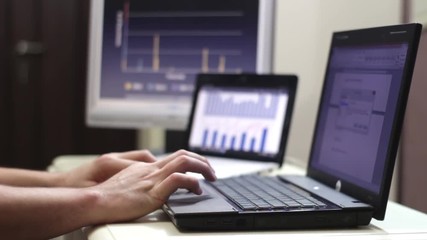 Businesswomans Working with the Charts and laptop in Office